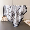 Detail of elegant silk-like square scarf with chain print draped in a luxury setting - 70x70cm / Black and White Print (FG134-4)