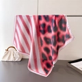 Detail of red striped and pink leopard print faux silk scarf with fine red edge stitching - Pink