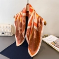 Vintage geometric star pattern silk scarf in orange and brown draped on a wooden hanger - 66-70CM / Brown (FG108-3)