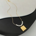 Gold titanium steel necklace with wave-edge square plate, Love Me engraving and white beads - Gold