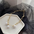 Golden chunky rectangle link chain necklace with three round pearls on a white tray - Gold