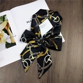 Elegant black and gold silk scarf with horsebit chain patterns tied in a bow - 17 Black with Belt Pattern