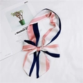 Pink and navy striped satin skinny scarf tied in a bow on a minimalist background - 33 Pink Vertical Stripe