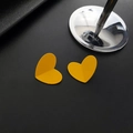 Minimalist matte yellow heart-shaped stud earrings with a textured spray paint finish - Heart Style / Orange