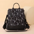 Waterproof black nylon floral backpack for women with white lavender prints and leather accents - Black