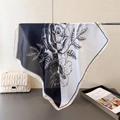 Detail showing the elegant black and white rose floral print on a silky square scarf - Black
