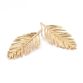 Golden leaf shaped stud earrings featuring detailed vein patterns and metallic finish - Gold