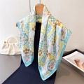 Elegant floral print satin silk scarf in white and blue, shown styled on a black dress - One Size / Light Blue