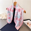 Elegant floral silk scarf with lobster print hanging on a wooden hanger with pearl handbag - One Size / Pink