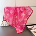 Detail of magenta paisley silk scarf showing soft satin texture and intricate patterns - 70x70cm / Pink