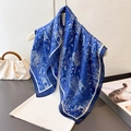 Navy blue paisley silk scarf with white patterns styled on a white knitted top - 70x70cm / Navy Blue