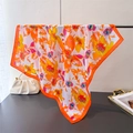 Detail of floral printed silk square scarf with vibrant orange edges and elegant drape - 70cmx70cm / Orange (FG231-4)