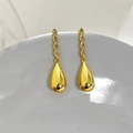 Macro detail of long 18K gold-plated dangle earrings with zircons and metal droplets - Gold Hollow Teardrop