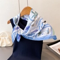 Detail of silk scarf with floral bird print tied on ribbed knit top with pearl bag - 66-70cm / Blue
