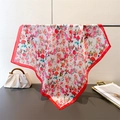 Detail of floral silk scarf with red border hanging elegantly in a stylish interior set - Red (FG179-1) / 66-70cm