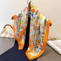 Floral print silk satin scarf with orange borders draped over dark clothing - Deep Blue Orange (FG179-4) / 66-70cm