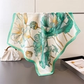 Detail of silk-like floral square scarf draped on a metal rod with green wide borders - Green