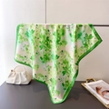 Detail of vibrant green floral print on square silk-like scarf with satin finish - 66-70cm / Green
