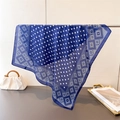 Detail of navy blue silk-like scarf with white polka dots and geometric diamond border - 66-70cm / Navy Blue