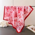 Close-up of elegant floral print silk scarf with a vibrant red border and smooth texture - 66-70cm / Red