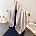 Elegant polka dot satin scarf in champagne gold hanging on a wooden hanger for styling - 66-70cm / Beige