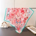 Detailed view of large floral butterfly silk scarf with mint green border on a metal rack - 70cm*70cm / Mint Green (FG238-1)
