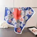 Detail of elegant navy blue and orange floral print on a square silk-like satin scarf - Navy Blue