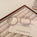 Elegant double-layer silver hoop earrings displayed on a soft textured jewelry tray - 4cm / Silver