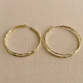 Detailed close-up of gold double-layered hoop earrings on a neutral beige canvas background - 5cm / Gold