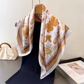 French style silk-like square scarf with yellow butterfly and floral print displayed on a rack - Brown / 70cm