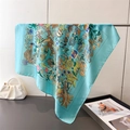 Detail of silk-like scarf featuring intricate blue jungle prints with wildlife patterns - Mint Blue