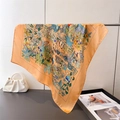 Luxurious orange silk scarf with elegant jungle giraffe and floral prints hanging - Orange