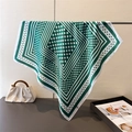 Detailed view of dark green polka dot silk-like scarf with elegant geometric patterns - 70x70cm / Green
