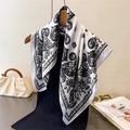 Elegant white silk square scarf with black cashew paisley floral print on wooden hanger - One Size / White