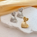 Detailed shot of gold and silver heart earrings on a natural stone and silk backdrop - Gold Heart Style (G219)