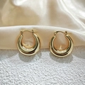 Close-up of golden chunky hoop earrings with polished finish on champagne silk - 25mm / Gold