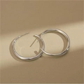 Close-up of minimalist silver hoop earrings with a polished mirror finish on a warm background - 2.5cm / Silver