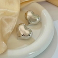 Polished silver heart-shaped hollow earrings in 18K gold plated brass on a silk background - Silver (E106)