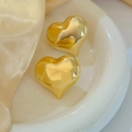 Polished 18K gold plated hollow heart earrings on white ceramic tray and silk - Gold (E106)