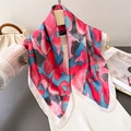 Silk satin square scarf with artistic pink and blue print on an elegant display - Pink