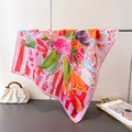 Detail view of large square satin silk scarf with colorful artistic floral oil painting prints - Pink