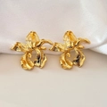 Detail of gold orchid earrings featuring brushed metal texture and floral design - Gold