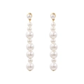 Elegant long pearl drop earrings with gold studs and glossy white beads on white background - White Graduated Long Pearl Drop Earrings (Main Color)