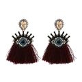 Macro shot of evil eye earrings featuring blue crystal inlay and deep red tassel details - Burgundy