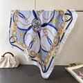 Detailed shot of luxurious silk scarf with gold chain print and leopard pattern texture - White