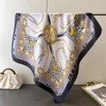 Detail of silk-like square scarf featuring chain prints and leopard patterns draped gracefully - Black