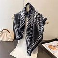 Polka dot silk-feel square scarf with geometric border styled on a white vest - Black