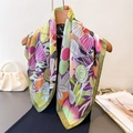 Bohemian silk-like square scarf featuring colorful floral prints on a wooden hanger - Green