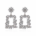 Exaggerated geometric flower earrings with sparkling rhinestones in a silver-toned setting - White