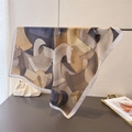 Detail of silk-like square scarf featuring abstract horse print in earthy brown tones - 70cm x 70cm / Light Khaki